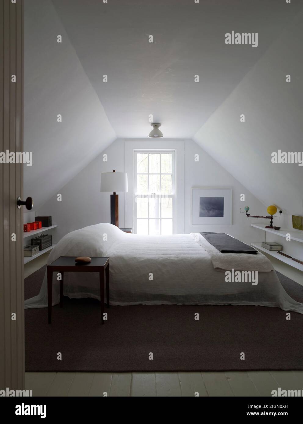 Double bed in attic bedroom in USA home Stock Photo - Alamy