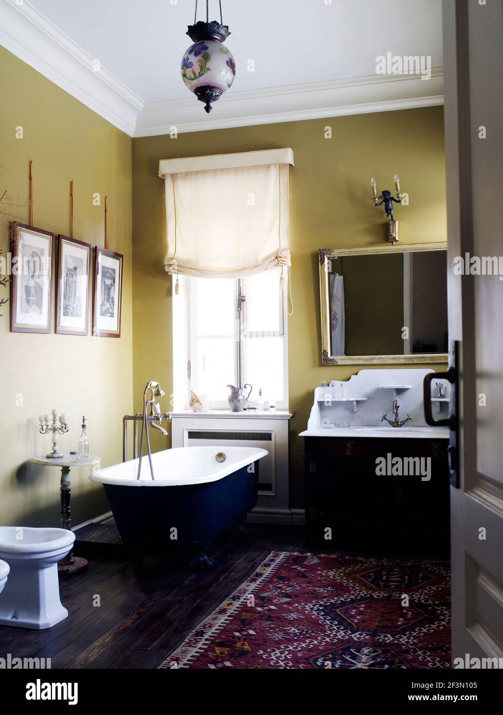 Freestanding roll top bathtub in bathroom in Russian home Stock Photo