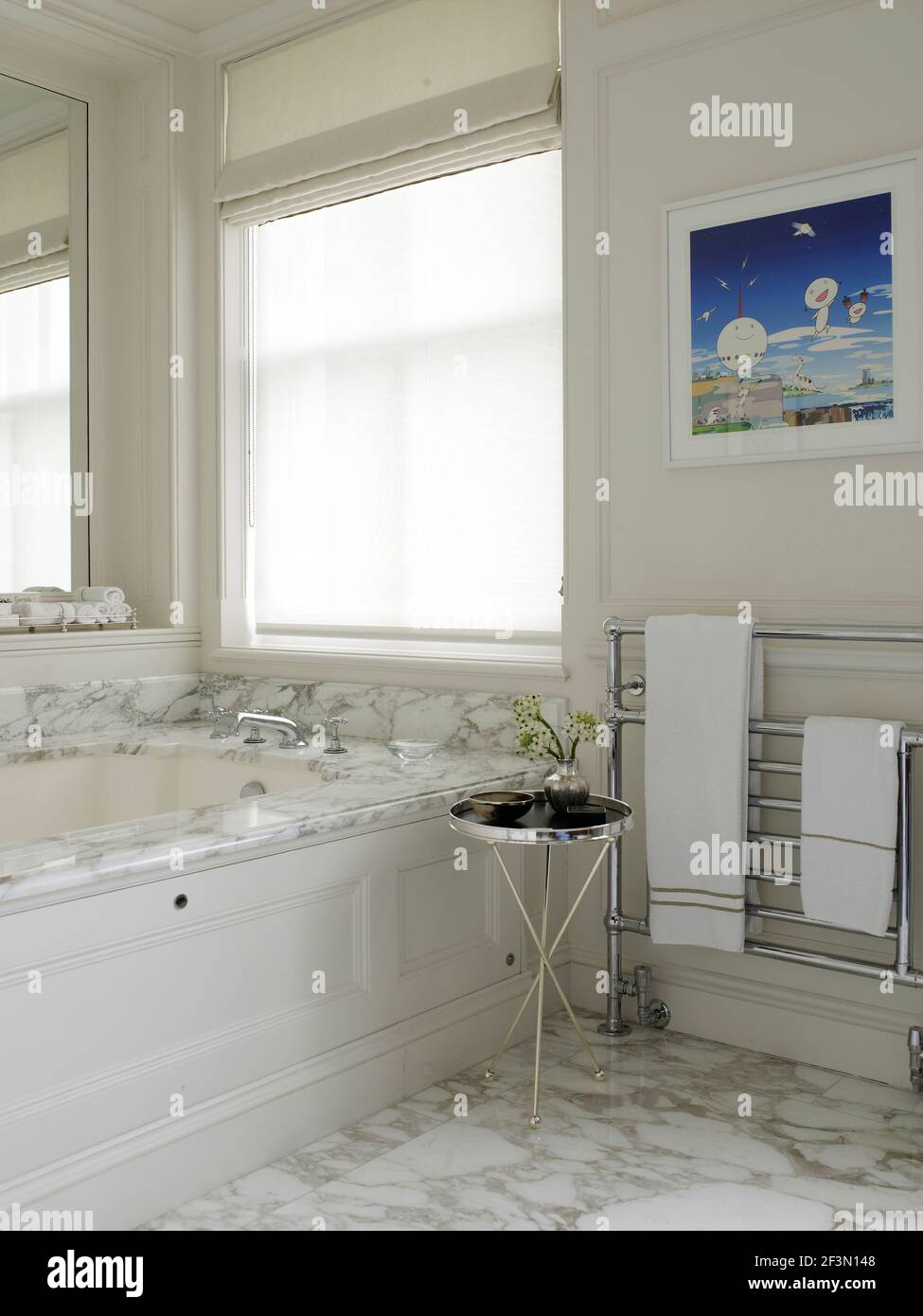 Marble bath in neutral bathroom in UK home Stock Photo Alamy