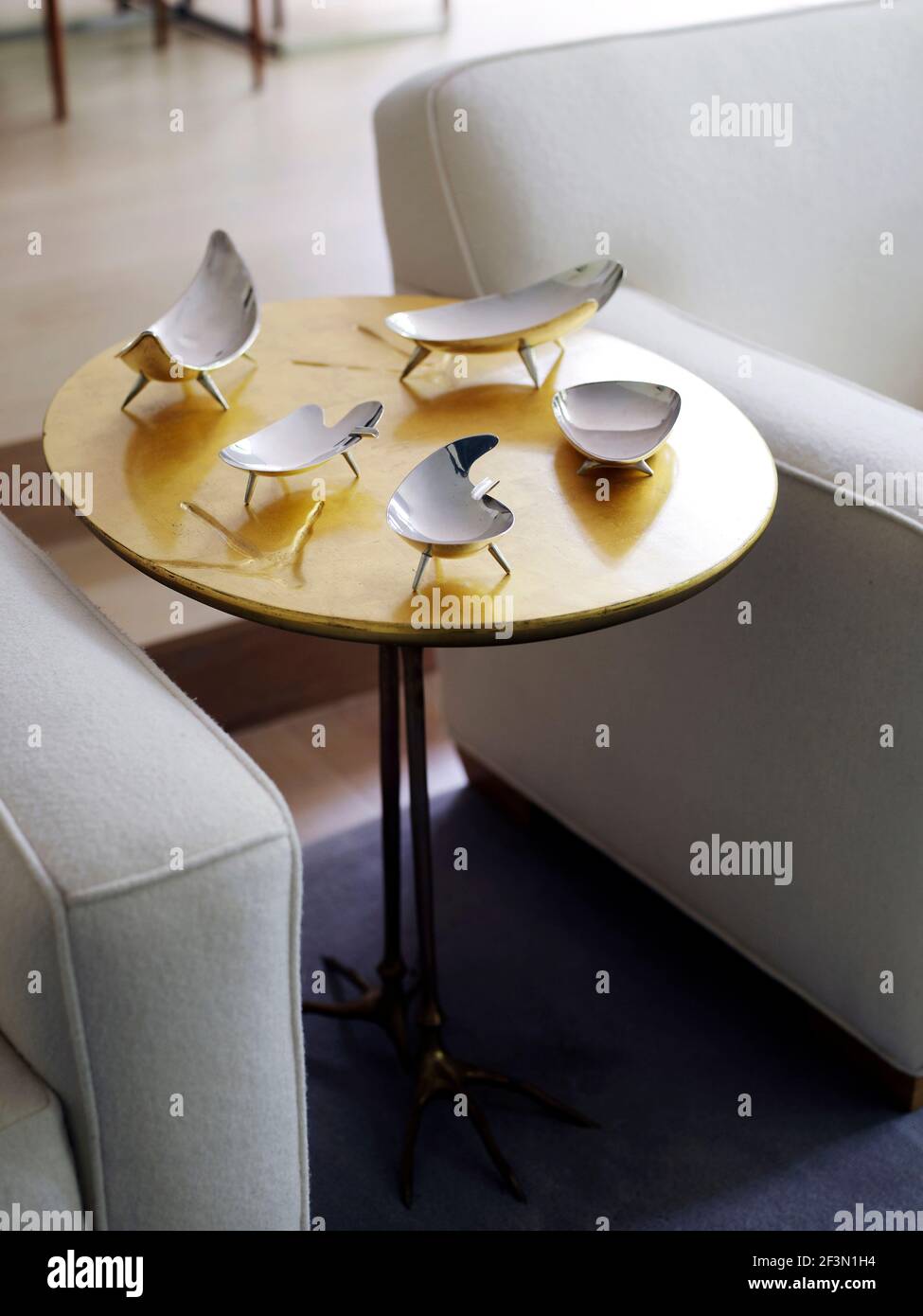 Silverware on round table in living room in Canadian home Stock Photo