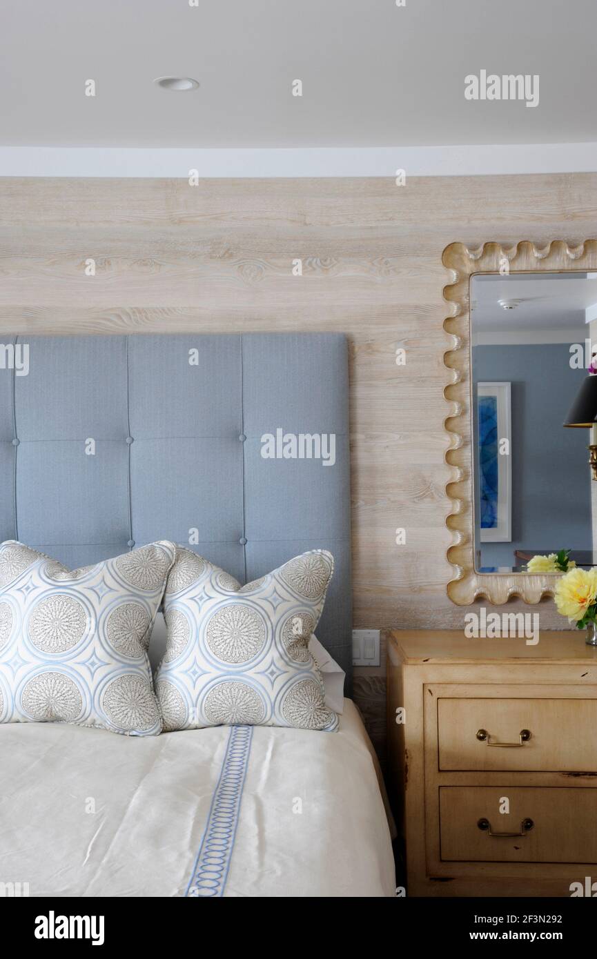 Double bed with light blue padded headboard, Cobble Court Interiors, designer Robert Rizzo, New Canaan, Fairfield County, Connecticut, USA Stock Photo