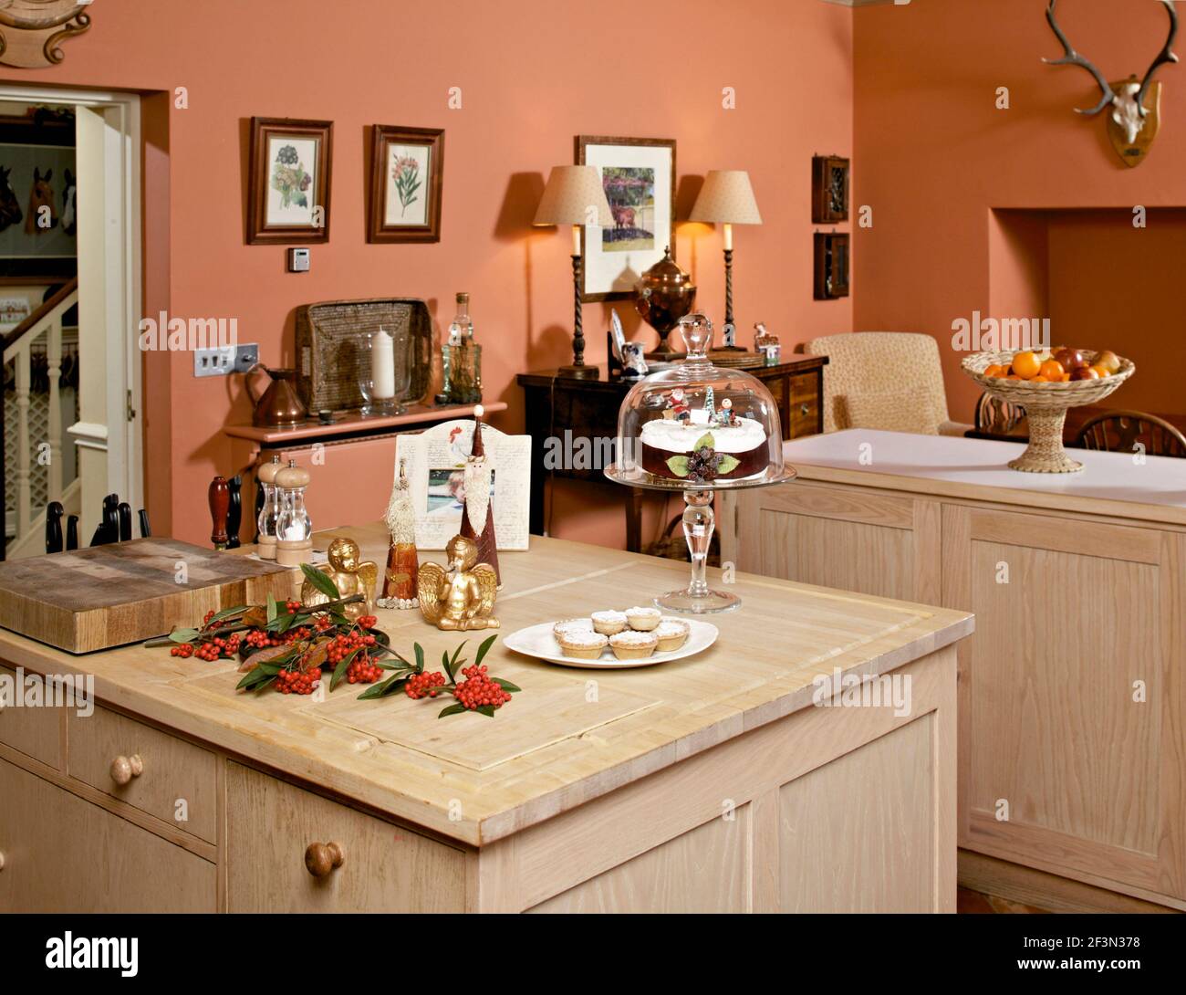 Terracotta kitchen with light wood units Stock Photo