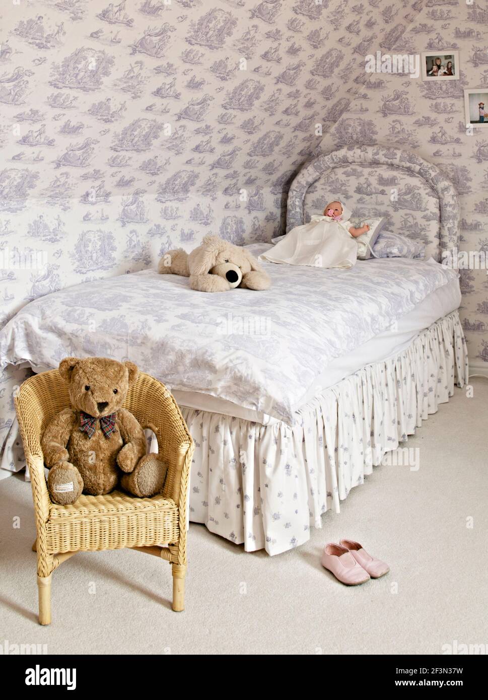Childs bedroom with Toile de Jouy wallpaper and matching bedcover on single bed Stock Photo