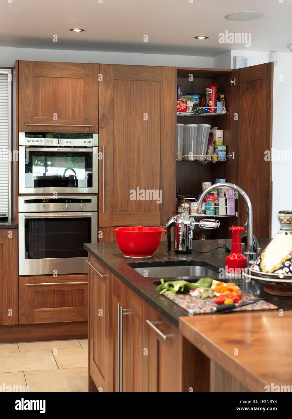 Modern kitchen with wood units, UK home Stock Photo
