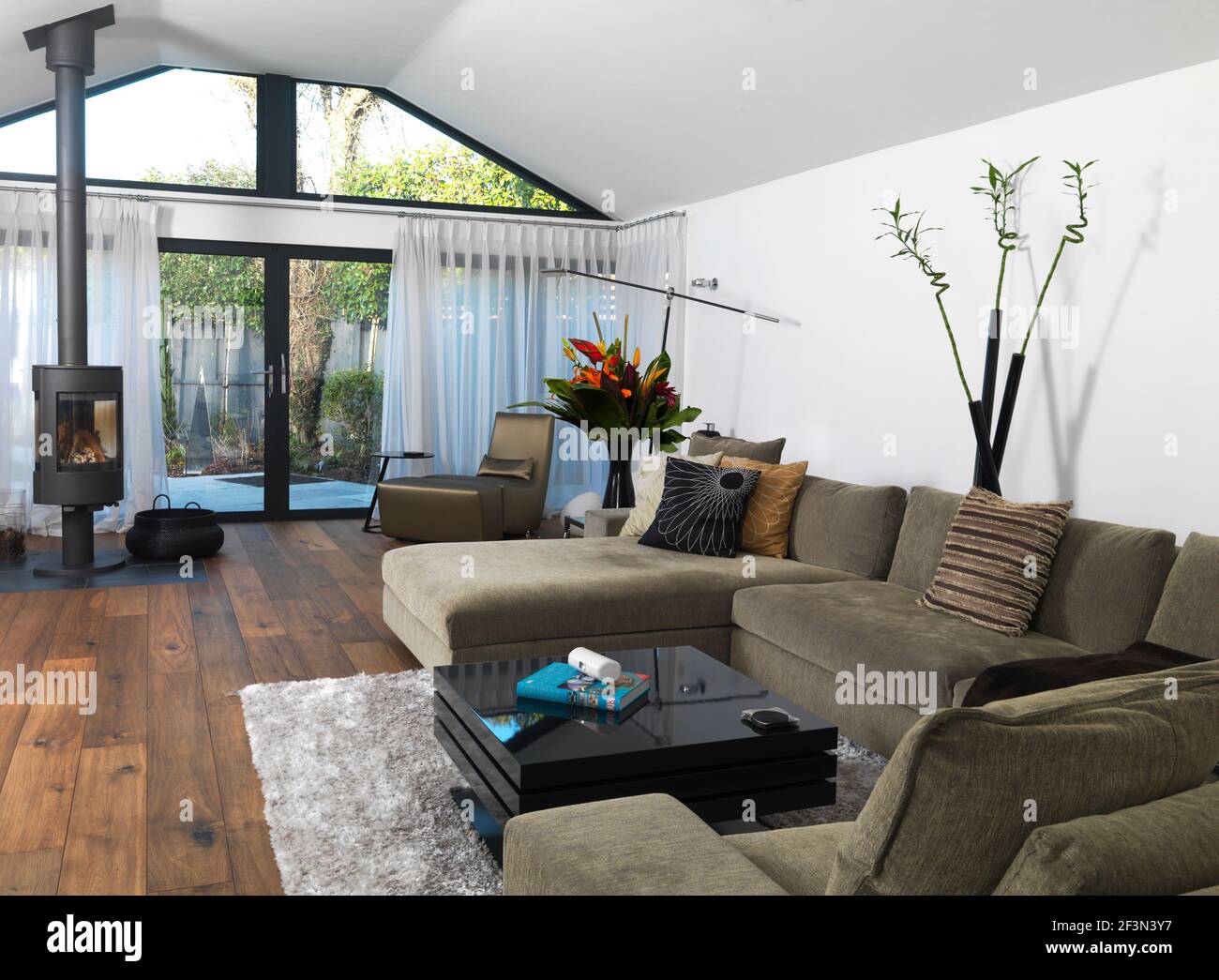 A contemporary open plan sitting room with log burner Stock Photo Alamy