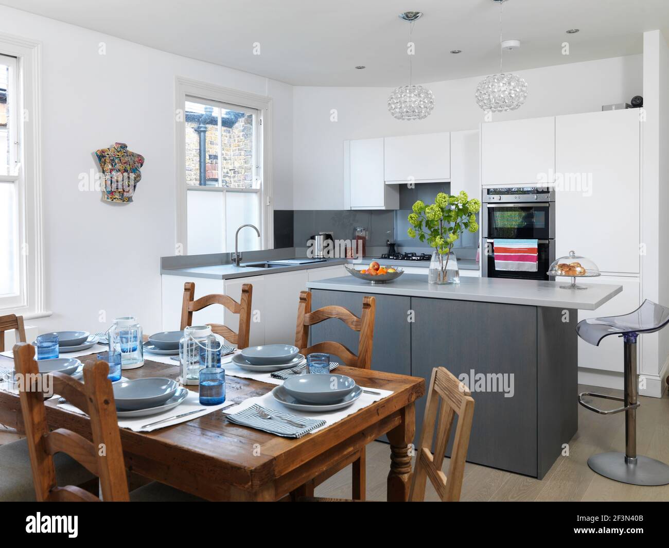 Wooden table set in modern kitchen, UK home Stock Photo Alamy