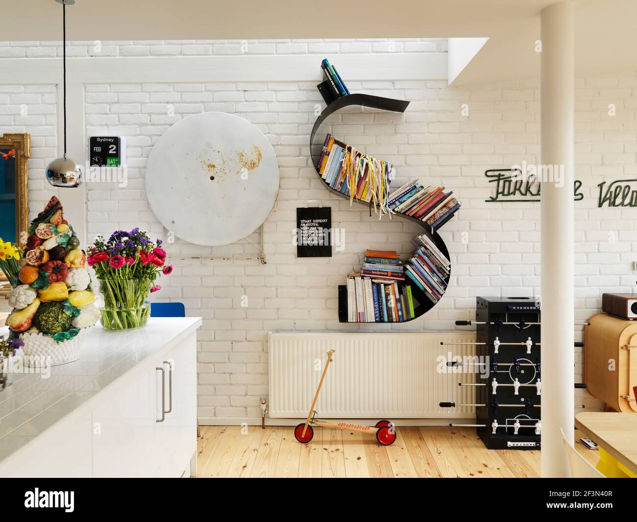 Kitchen with white painted brick wall and skylight, UK home Stock Photo