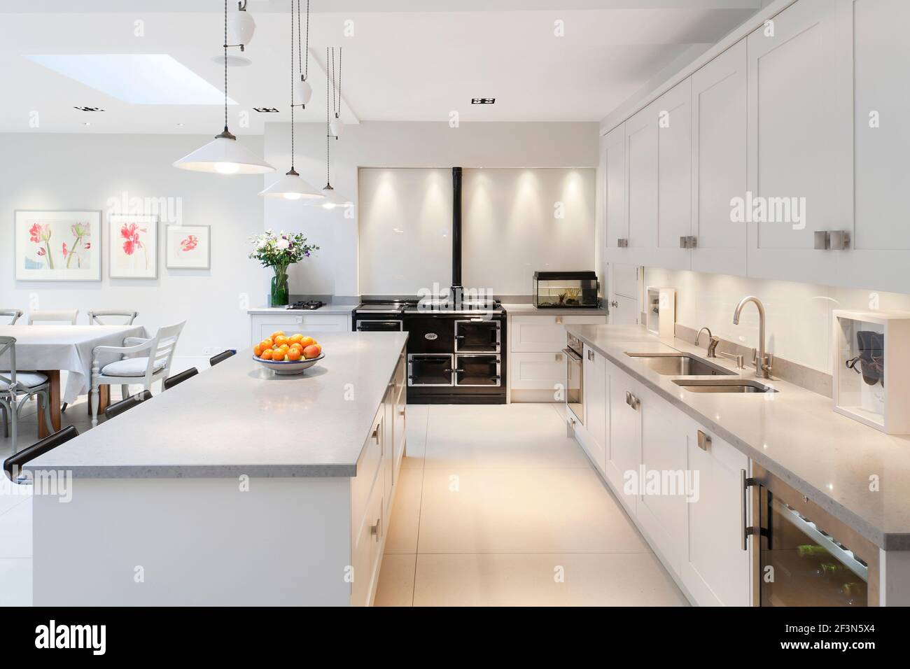 Large family home in Wandsworth, with basement and open plan kitchen extension. Kitchen with central island and black AGA oven. Stock Photo