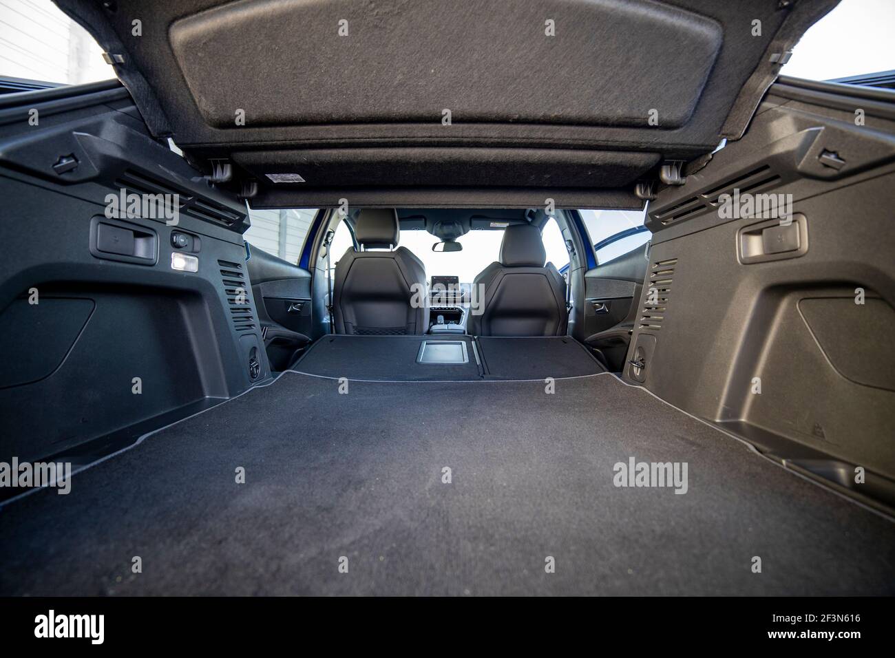 empty trunk of a modern car with folded rear seats. large interior volume. trunk view. Stock Photo