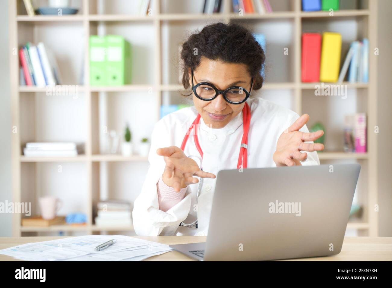 Doctor helping patient via telehealth making video call Stock Photo