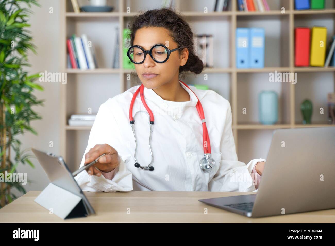 Doctor helping patient via telehealth making video call Stock Photo