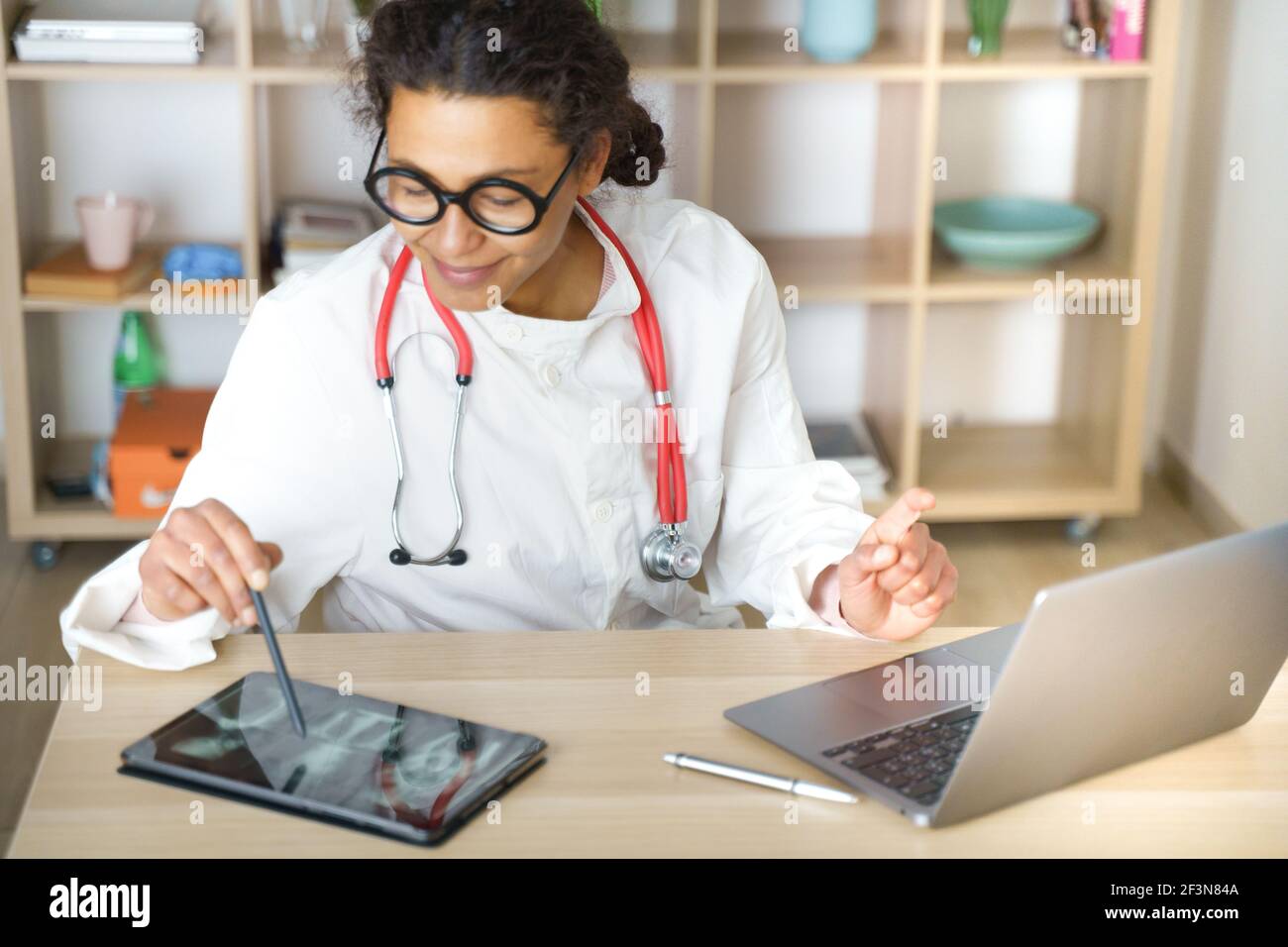 Doctor helping patient via telehealth making video call Stock Photo