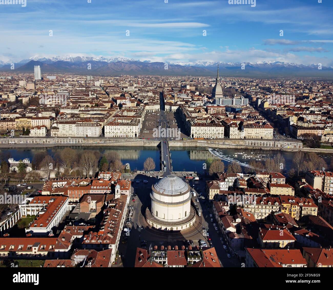 Aerial view of Turin city center, in Italy, in a sunny day, with Mole Antonelliana and Alps in the background. Stock Photo