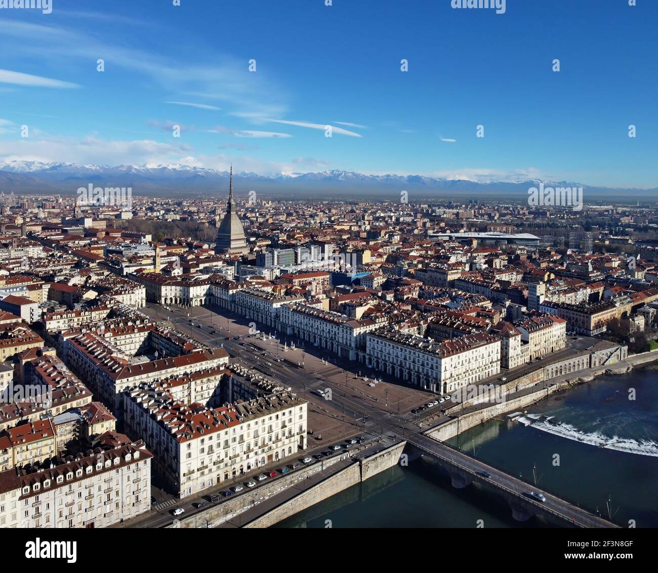 Aerial view of Turin city center, in Italy, in a sunny day, with Mole Antonelliana and Alps in the background. Stock Photo