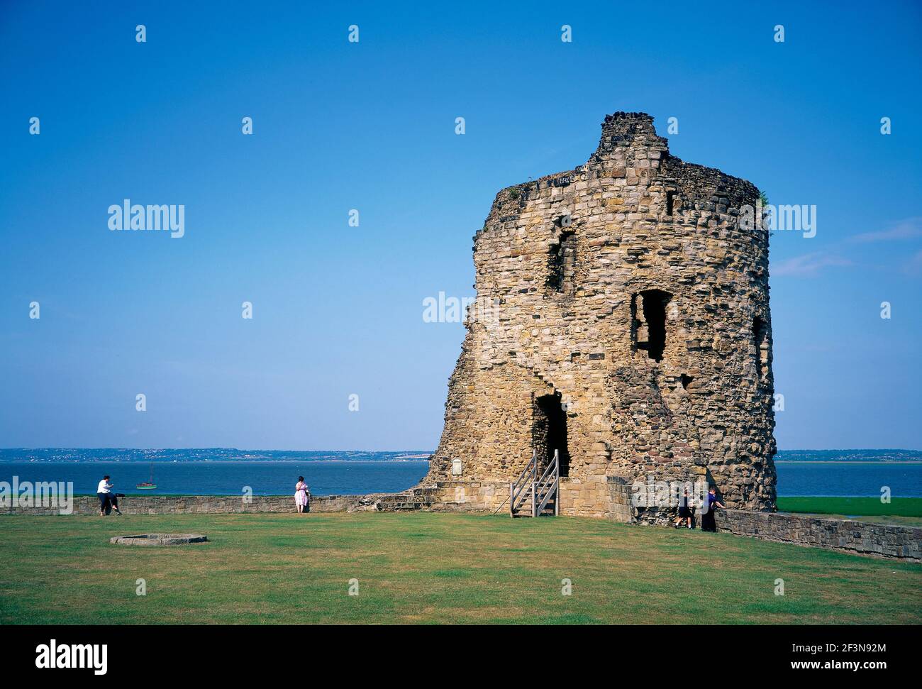 Flint Castle. Crumbling remains of old North East stone tower. Sea in background. Boat. People. Flintshire.   returned 1,5,07. Stock Photo