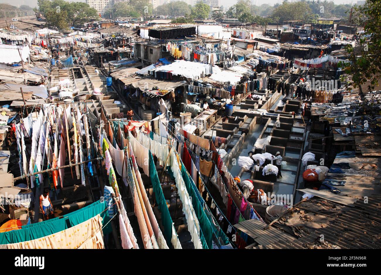 The Dhobi ghat laundries are special areas of the city, with row upon row of concrete wash pens, each fitted with its own flogging stone. Clothes sent Stock Photo