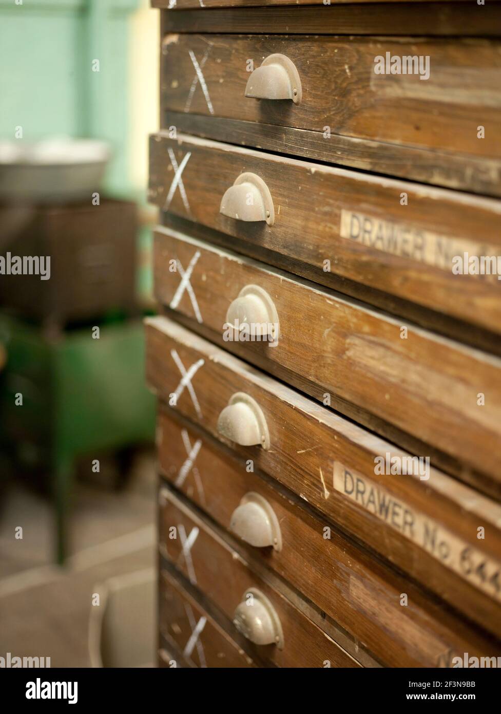 Old fashioned map drawers in a dusty storeroom. Library or archive