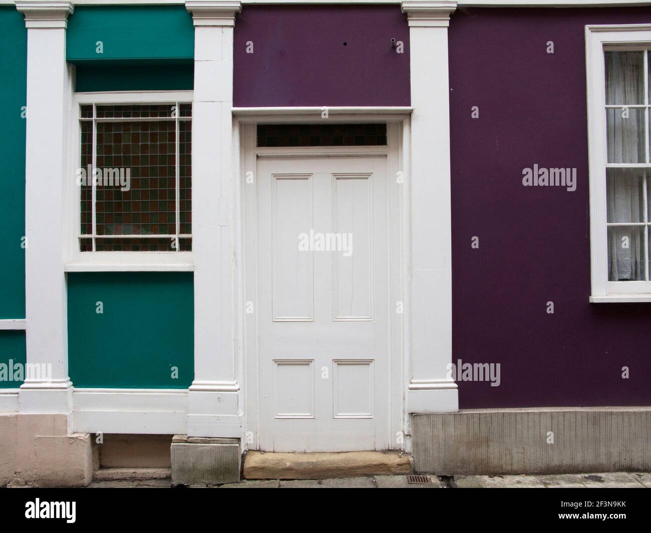 Oriel Street in Oxford has rows of small buildings with historic and brightly painted facades. Stock Photo