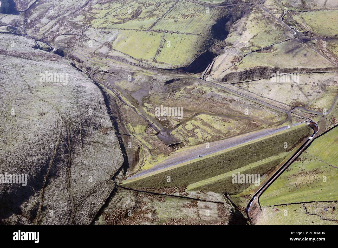 Aerial view of an empty dried up reservoir near Todmorden. This being Ramsden Clough Reservoir. Stock Photo