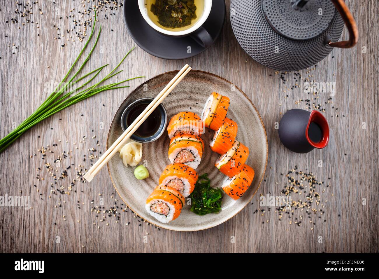 Sushi maki rolls with spicy crab, salmon, cucumber on a plate with