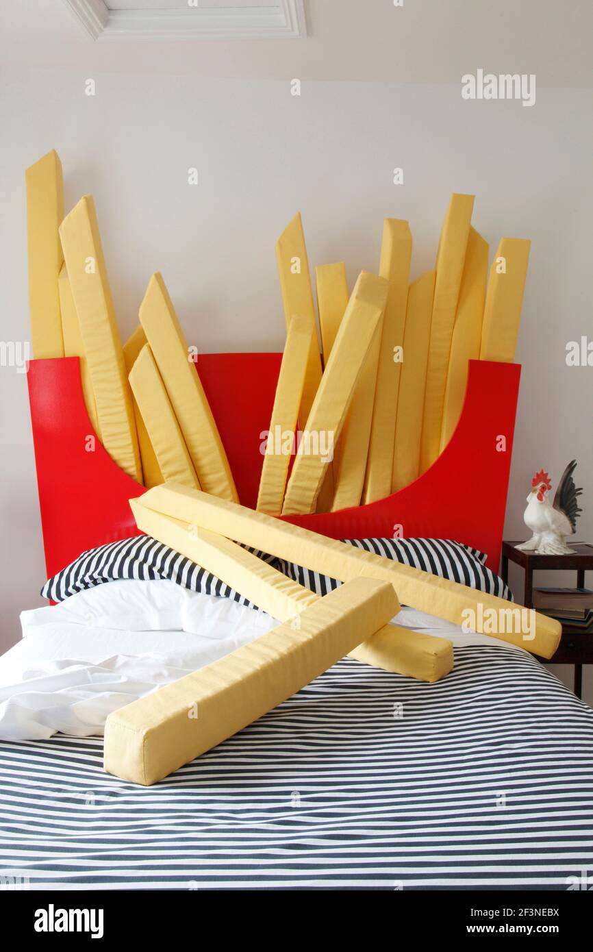 Bed with giant chips scattered Designer Harry Parr Stock Photo Alamy