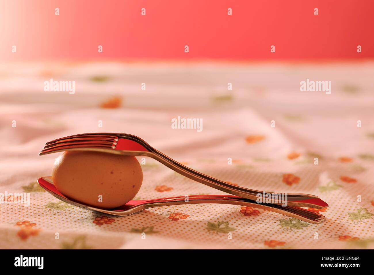 plastic forks with egg on a red background Stock Photo