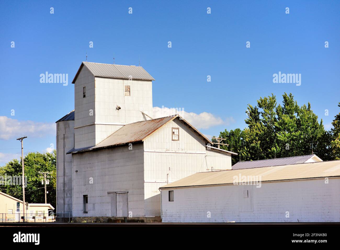 Big Rock, Illinois, USA. A venerable corrugated metal grain elevator sitting along railroad tracks in a small agricultural community Stock Photo
