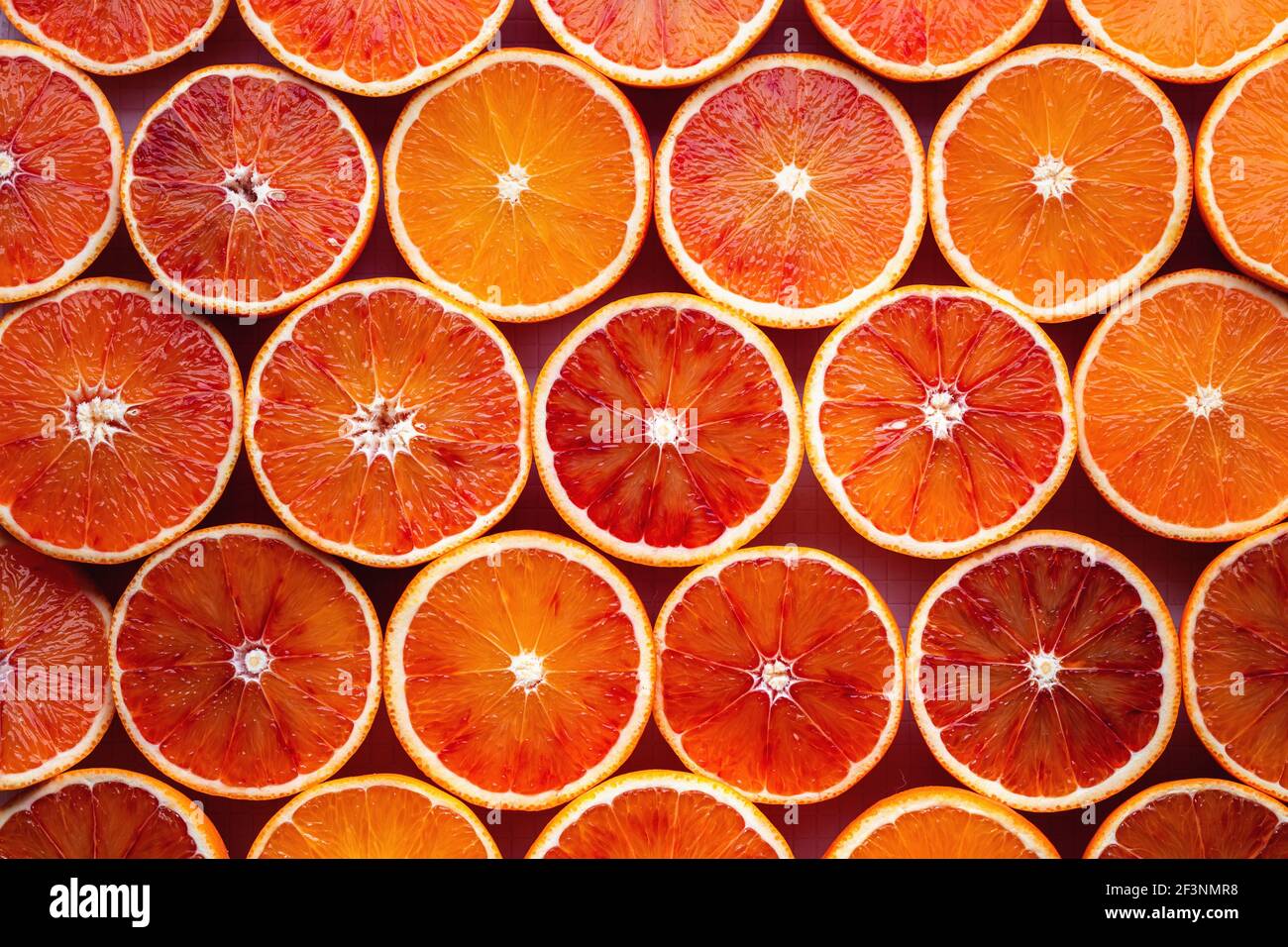 Pattern of sliced oranges prepared for juice making Stock Photo