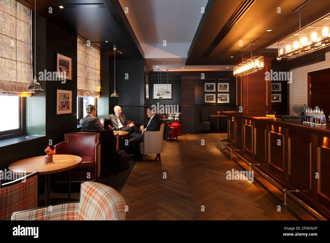Businessmen sitting around a table near the bar |  | Designer: RPW Stock Photo