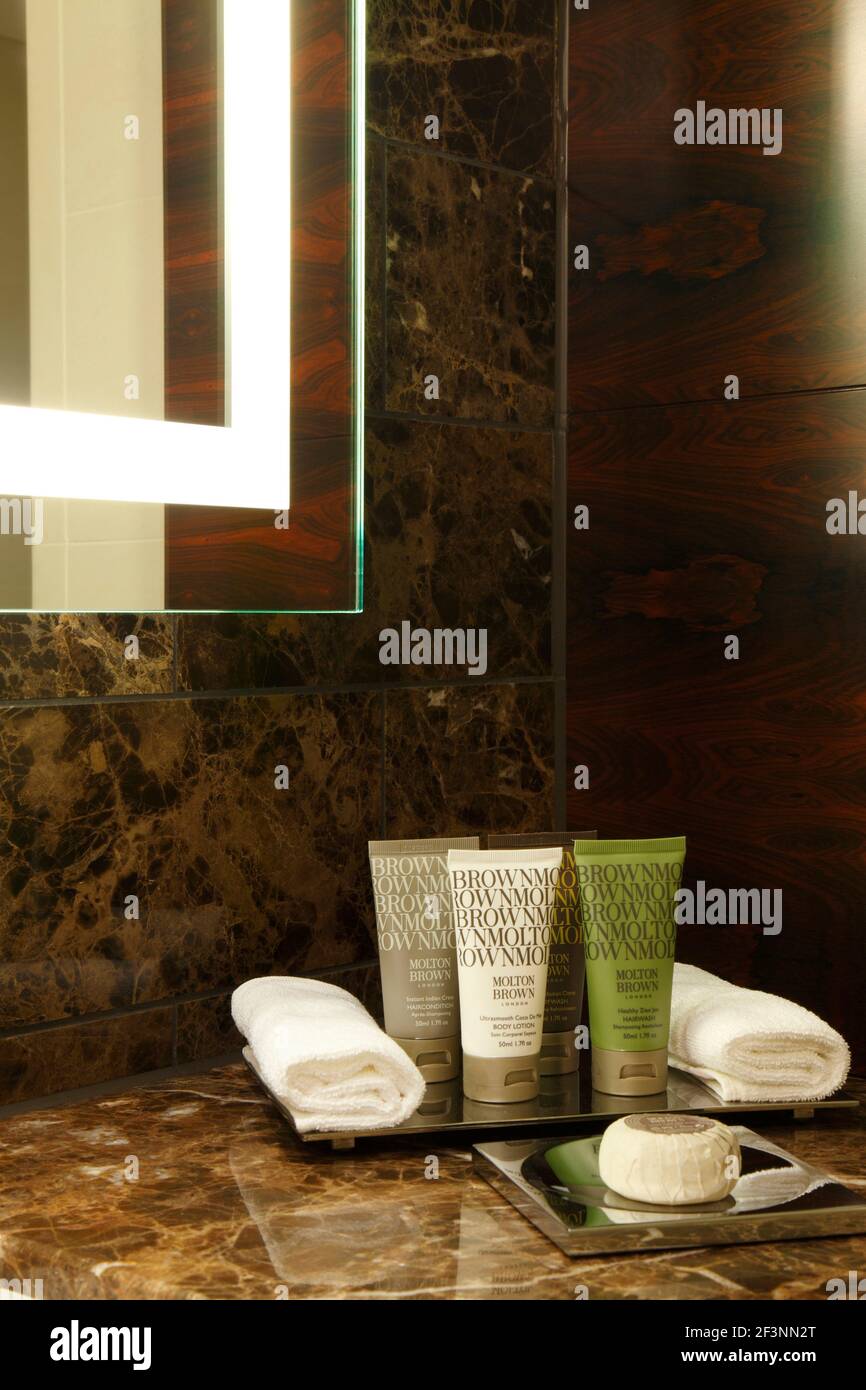 Bathroom products on brown marble vanity unit Designer RPW Stock