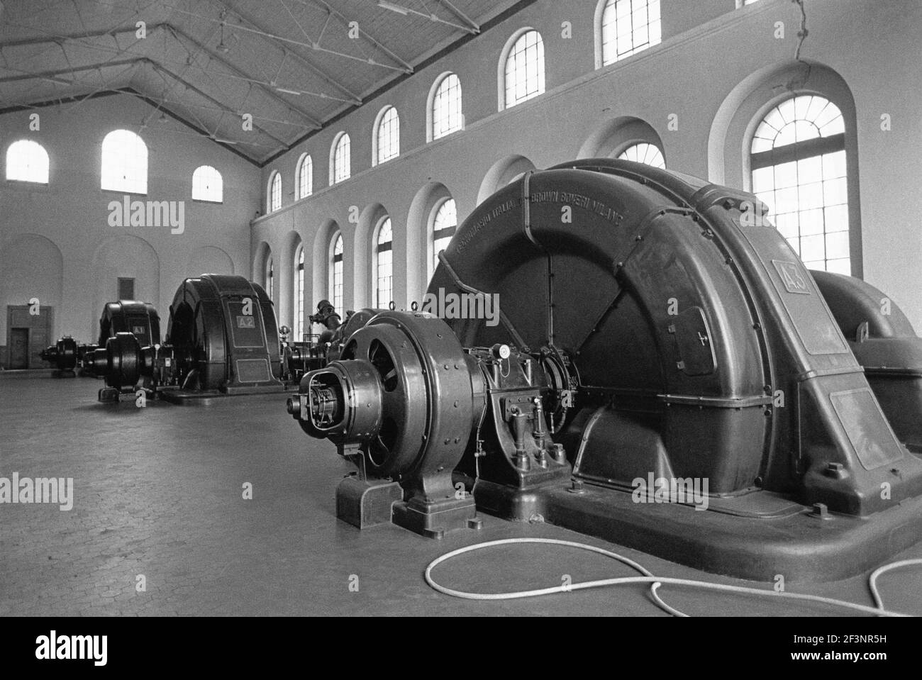 Old turbine room of 1910 year in Grosotto hydroelectric power station of AEM (Municipal Energetic Company of Milan, Italy) in Valtellina Stock Photo