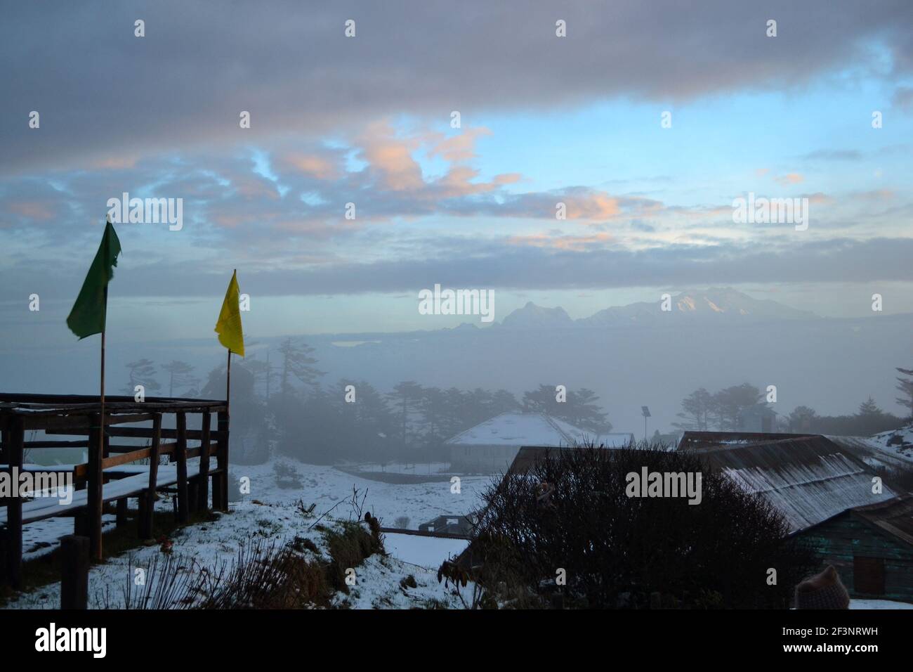 At the crack of dawn the sun peaks out from behind mountain tops the clouds  become lit with a fabulous, warm light with pine in the background watchin  Stock Photo - Alamy