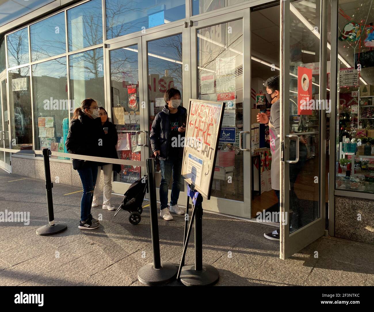 Employee letting customers inside Daiso Japan Store on Black Friday, Rego Center Mall, Queens, NY Stock Photo
