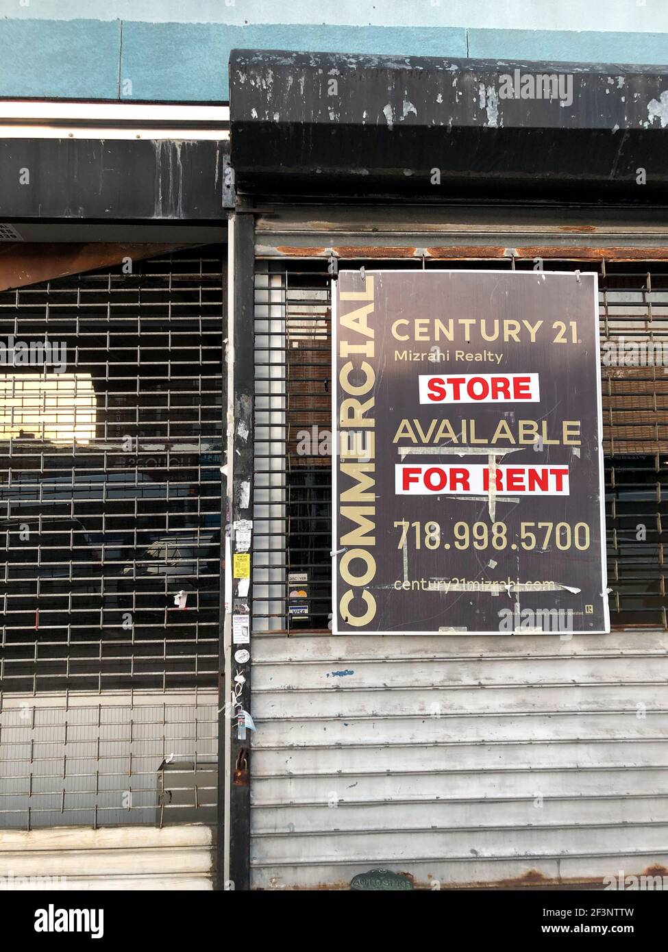 Commercial space for rent sign on closed storefront, Queens, New York