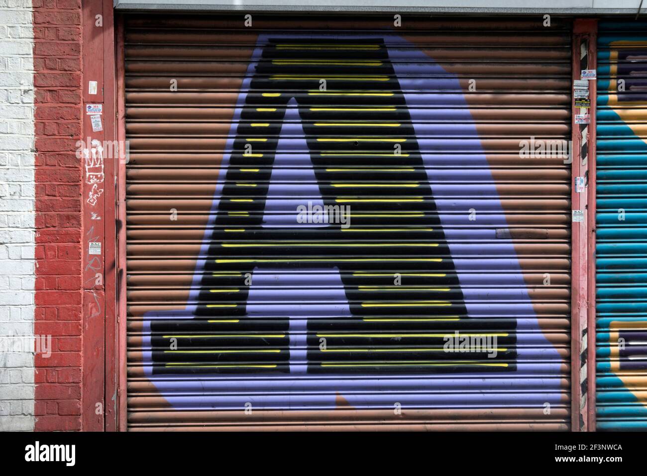 Ben Eine. Street art, a large initial A painted on metal scrolling