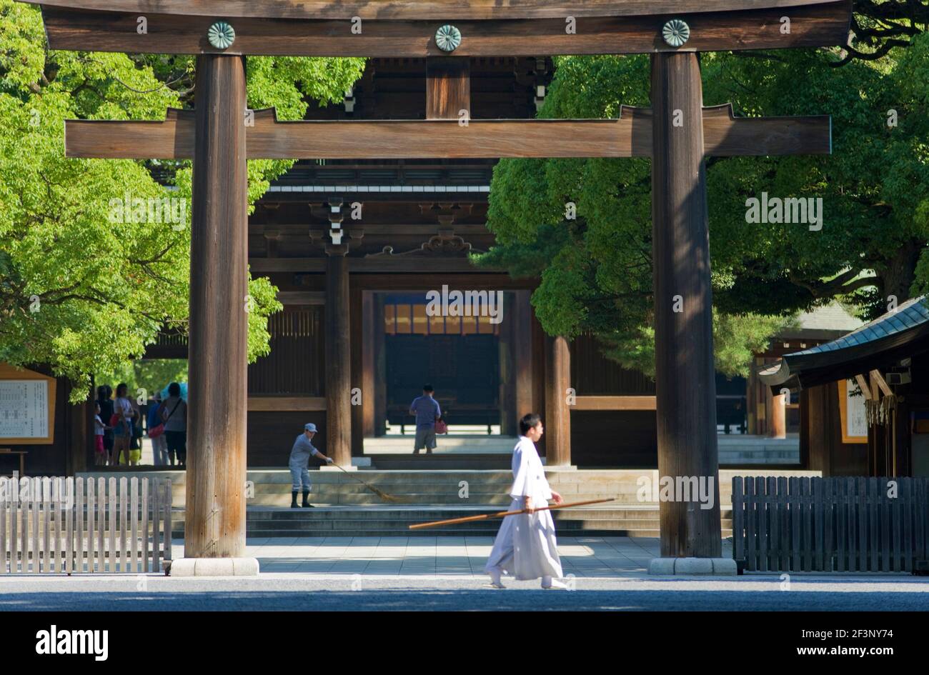 A large Tori gate made from hinoki Japanese cypress wood and featuring the Imperial Chrysanthemum Crest stands at the entrance to the central sanctuar Stock Photo