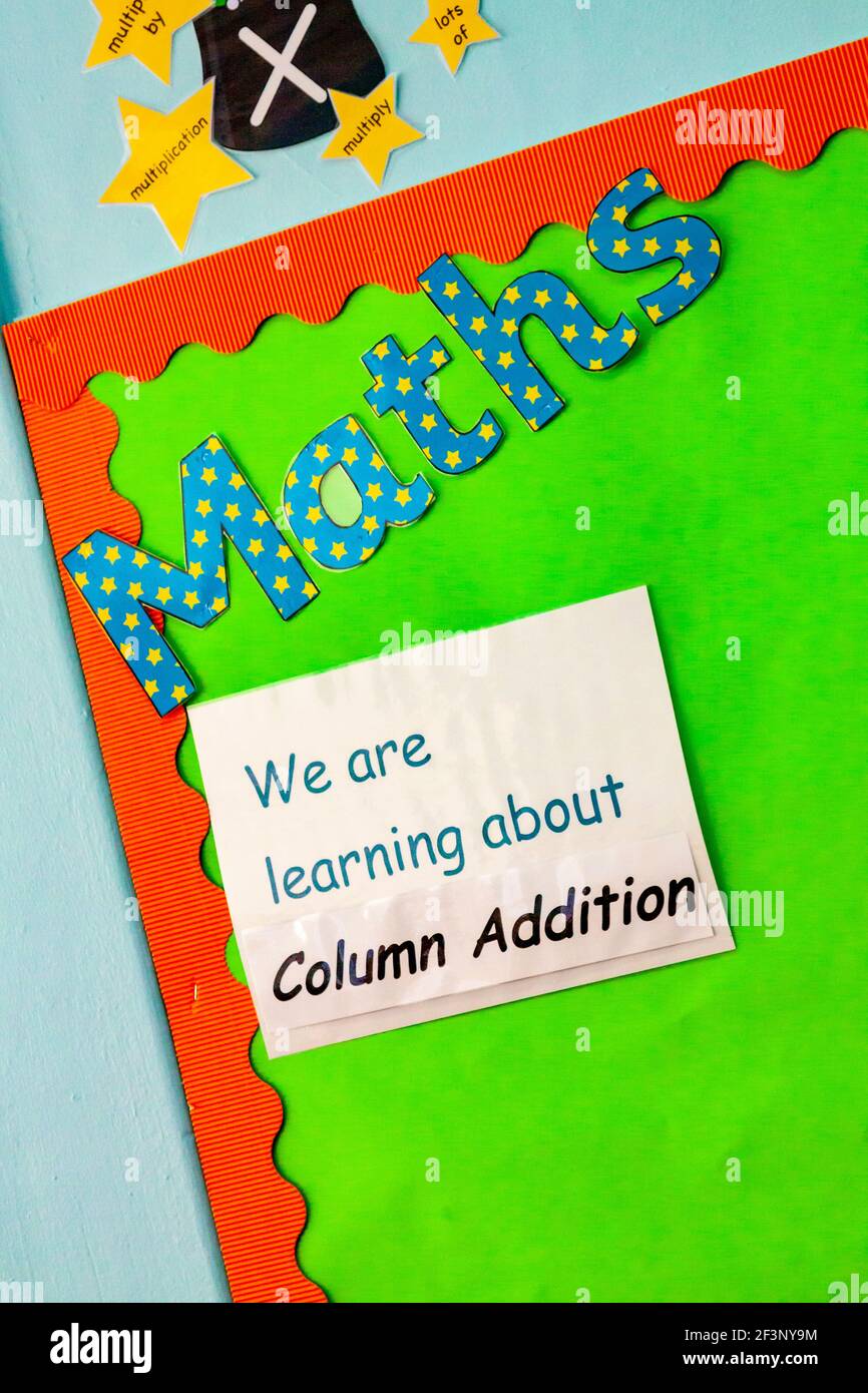Notice on the wall of a primary school classroom about maths and learning about column addition. Stock Photo