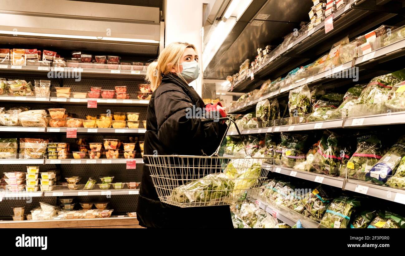 London UK, March 17 2021, Young Woman Shopping For Fresh Vegetables In