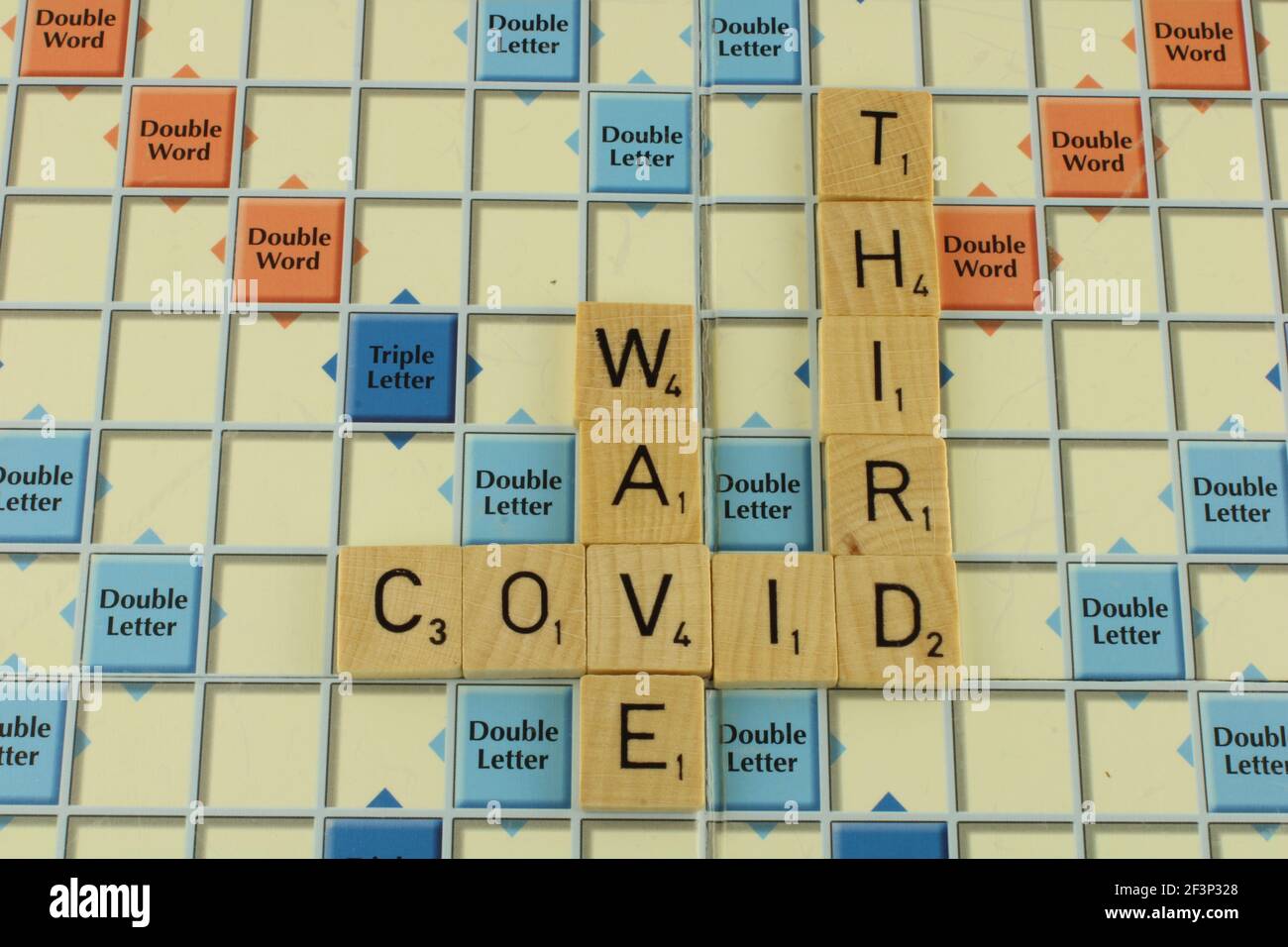 Covid third wave on a scrabble board Stock Photo