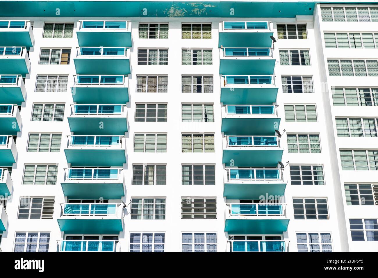 Abstract minimalist minimalism exterior architecture facade of art deco white turquoise teal colorful vintage retro residential building hotel with ba Stock Photo