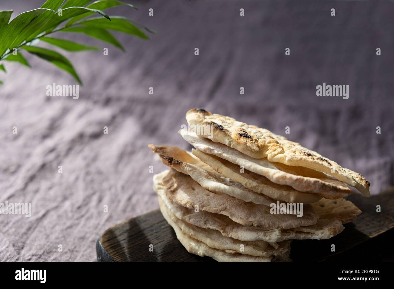 Homemade matzo with microgreen peas. Unleavened flatbread bread. Pesah celebration concept