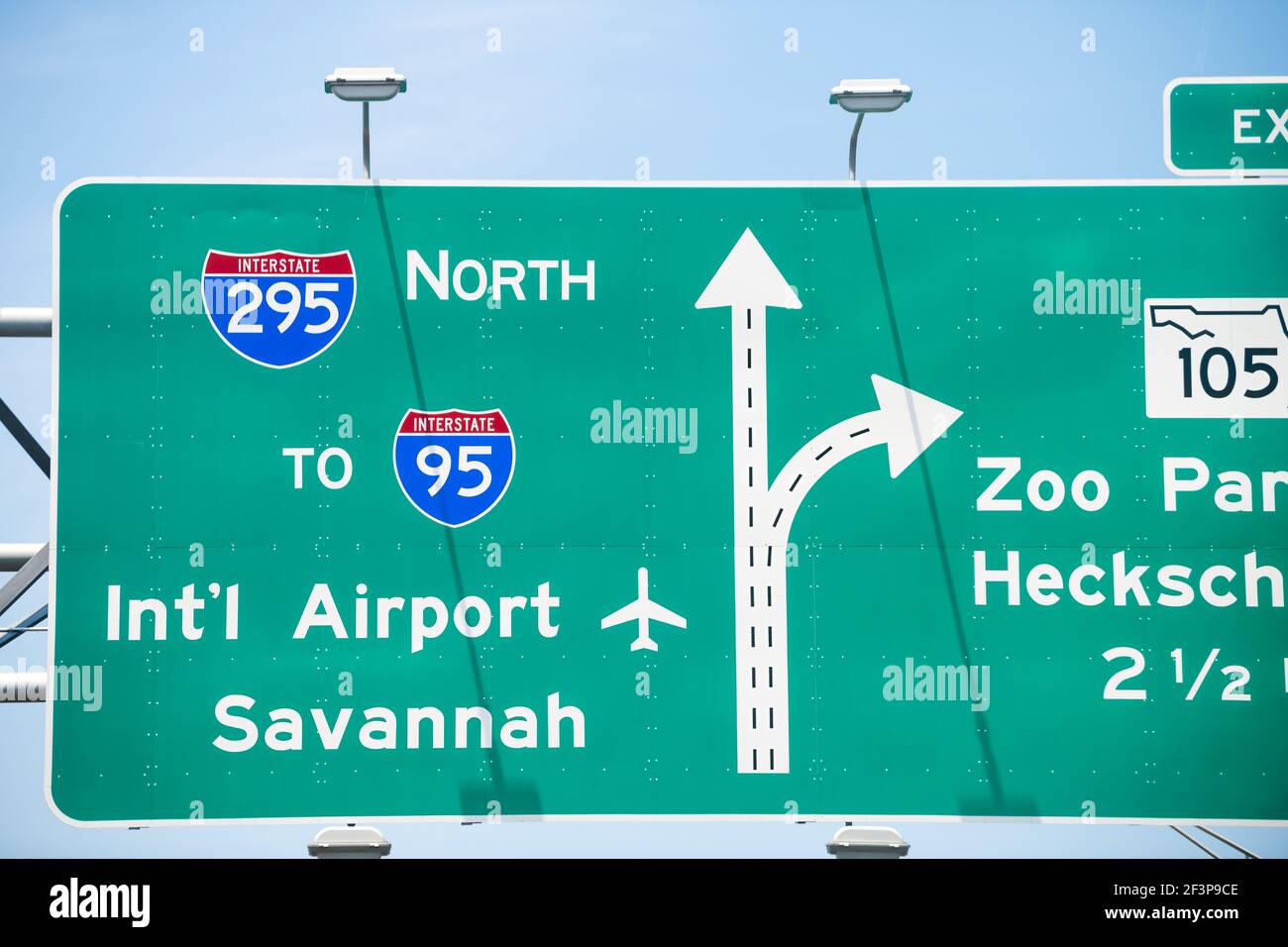 Jacksonville, Florida interstate highway 295 with traffic road sign to i-95 international airport of Savannah and Zoo parkway with cars driving in sum Stock Photo