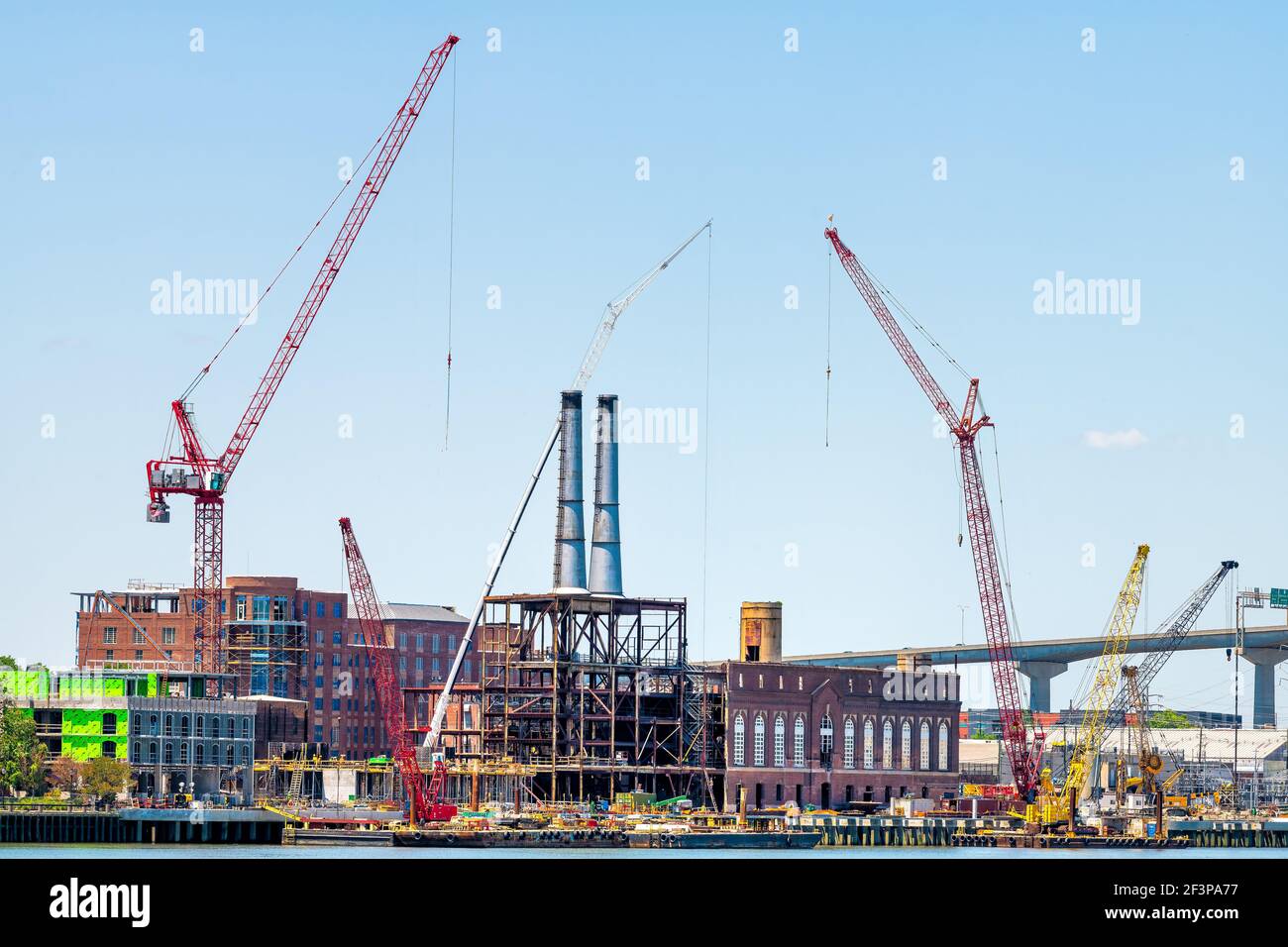 Savannah river waterfront with construction development site by cranes
