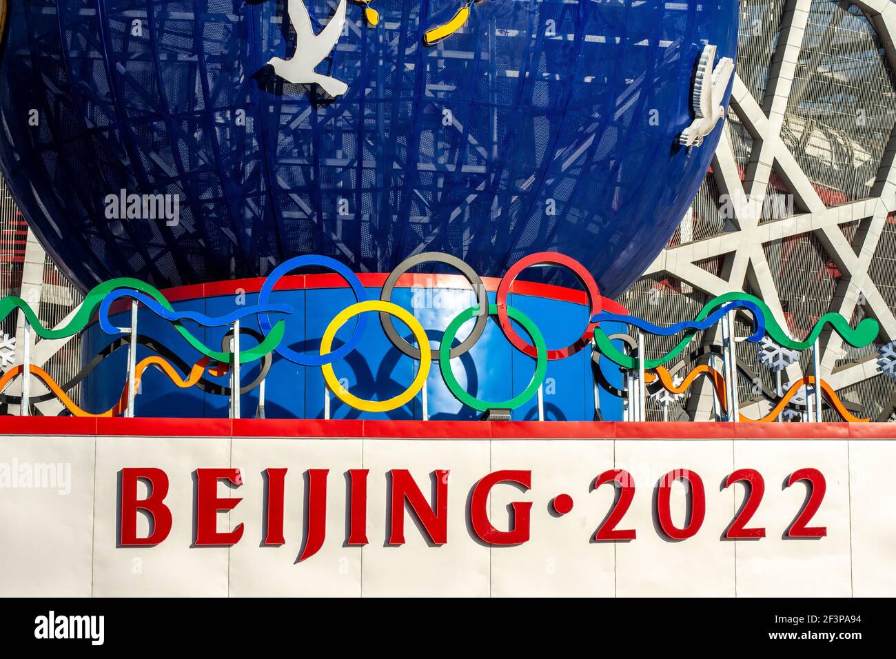 Beijing, China - February 20, 2016: Decorative stand promoting the Beijing Winter Olympic 2022 in front of the Beijing National Stadium Bird's Nest in Stock Photo