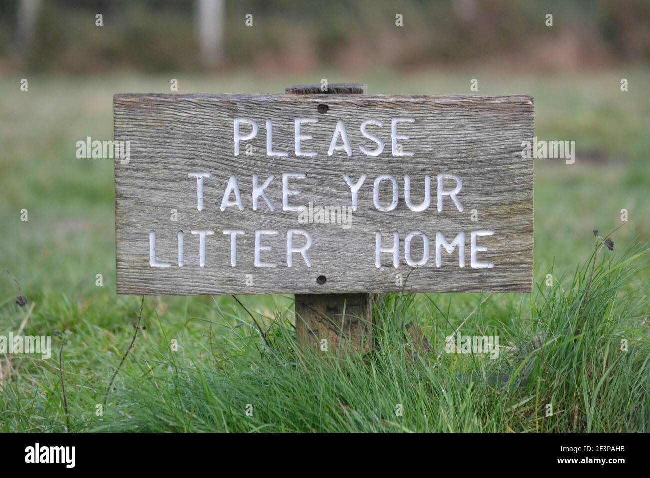Please Take Your Litter Home Wooden Sign On Ashdown Forest - Countryside Climate Change - Recycle Your Rubbish - White Letters Wooden Sign - Sussex UK Stock Photo