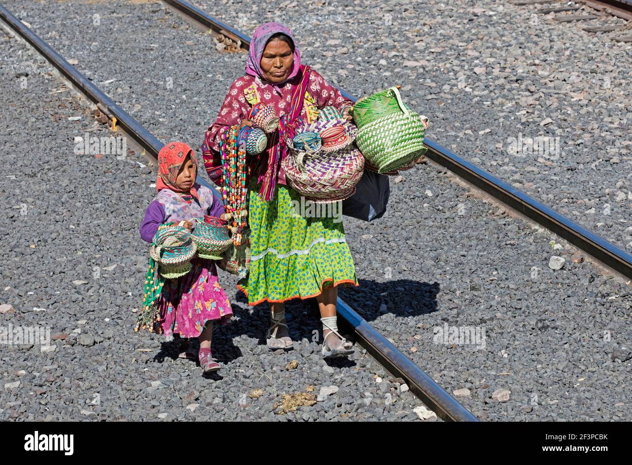 Mexican woman with child selling souvenirs to tourists on the tourist train of the Chepe Express / El Chepe / Chihuahua Pacifico in northwest Mexico Stock Photo