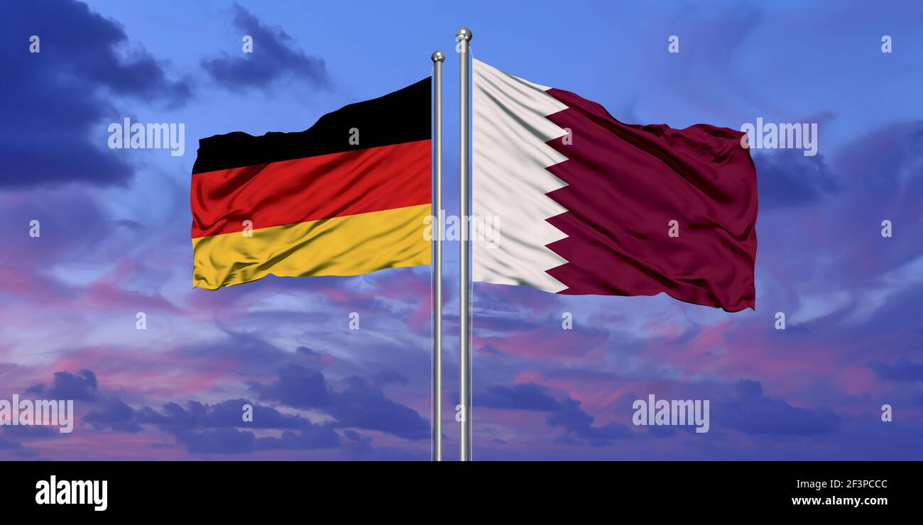 Germany and Qatar flag waving in the wind against white cloudy blue sky together. Diplomacy concept, international relations. Stock Photo