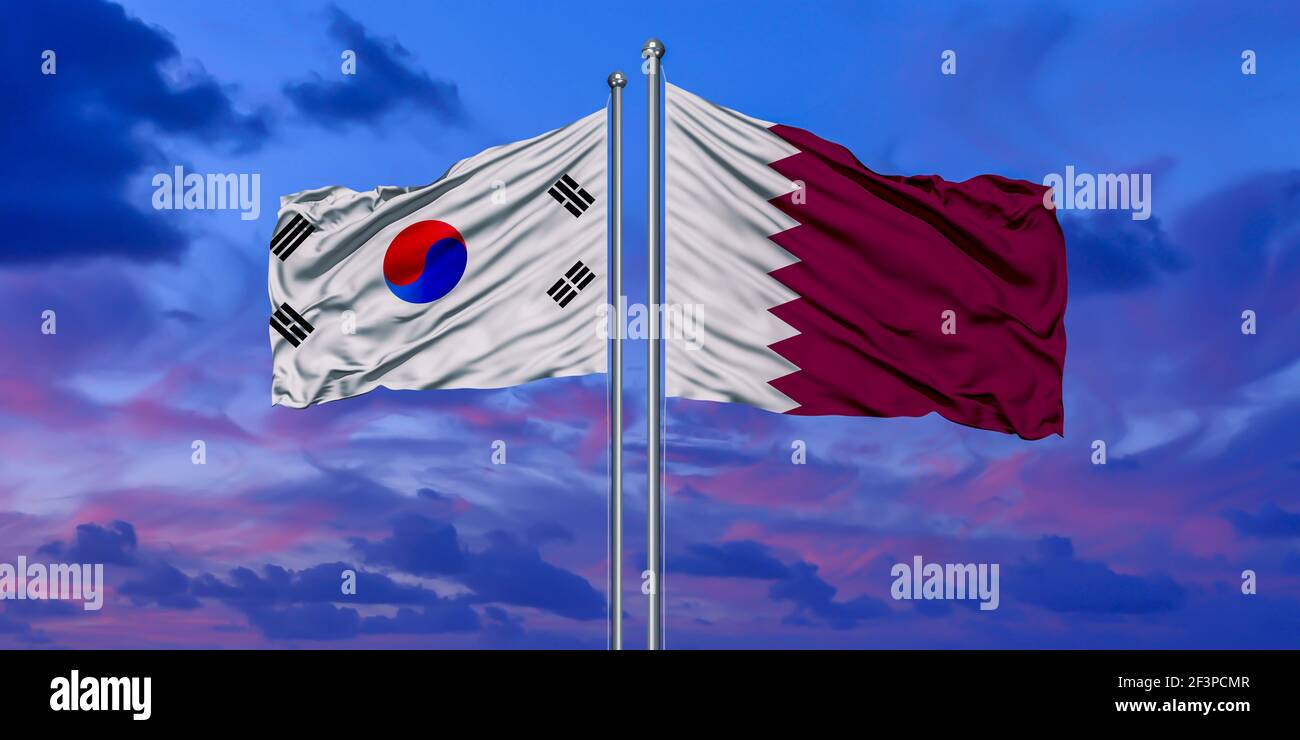 South Korea and Qatar two flags on flagpoles and blue cloudy sky Stock Photo