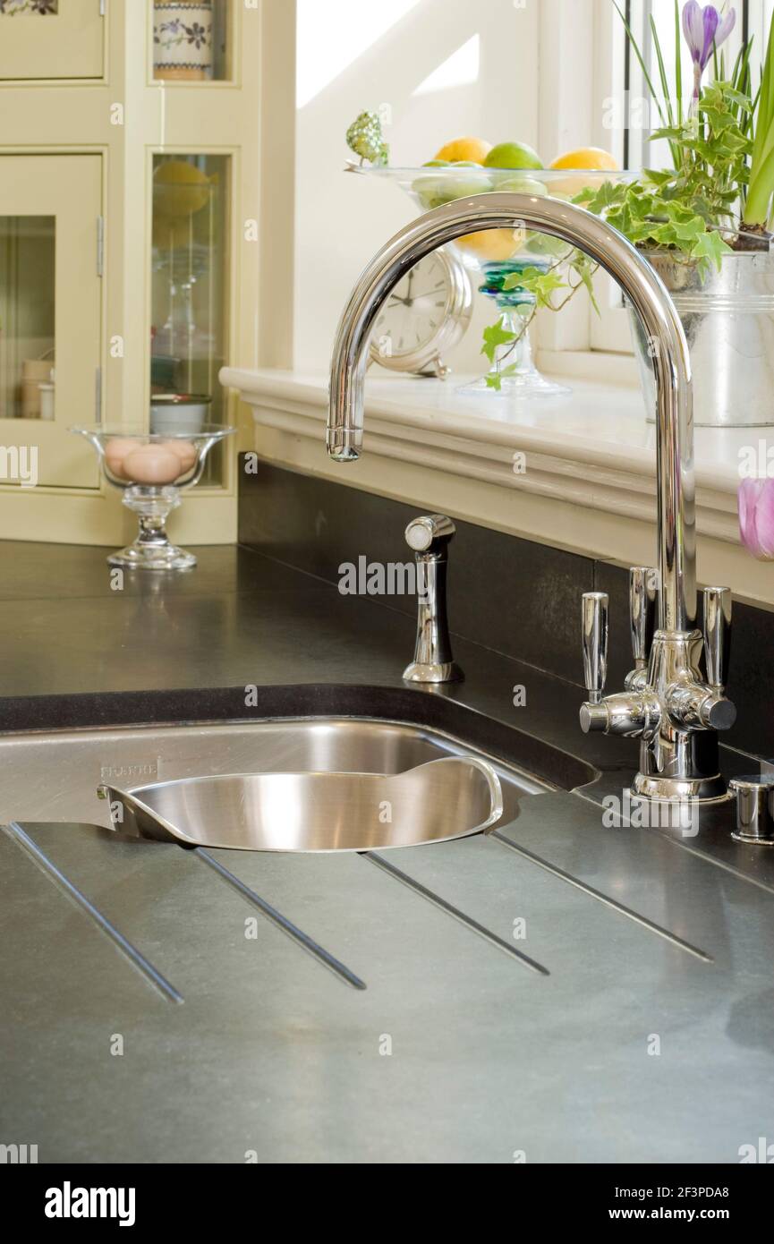Traditional style mixer tap fitting over kitchen sink Stock Photo Alamy