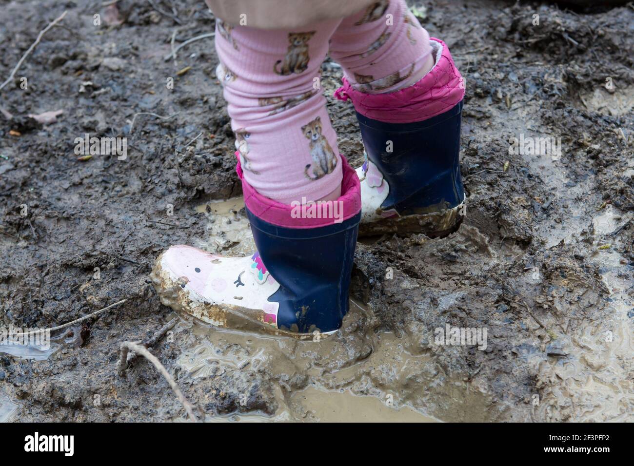 Splashing in mud with wellies on Stock Photo